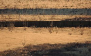 Grasslands and border wall near near Christiansen Ranch